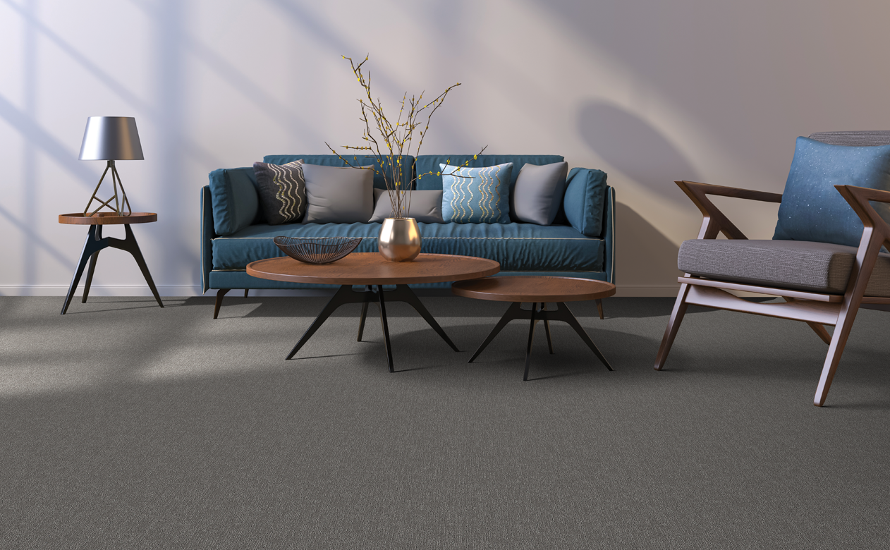 Living room with grey carpet, blue sofa and wood coffee tables